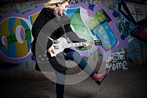 Female teenager playing guitar