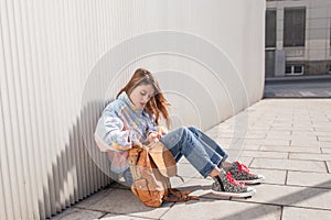 Female teenager student sitting on the floor