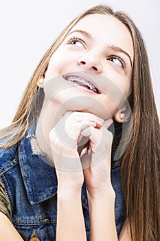 Female Teenager With Teeth Braces. Posing With Lifter Head Looking Upwards.