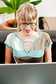 Female telecommuter and sofa business photo