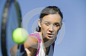 Female Tennis Player Hitting Ball close up of racket focus on player photo