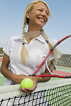 Female Tennis Player at net on tennis court