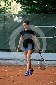 Female tennis player with racket gear in tournament match outdoor