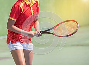 Female tennis player with racket preparing to play tennis during competition in the tennis court