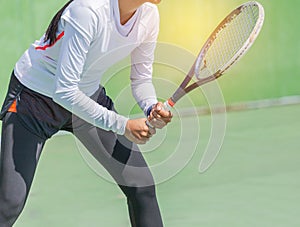 Female tennis player with racket preparing to play tennis during competition in the tennis court