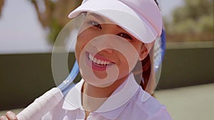 Female Tennis Player with Racket Wearing Sun Visor