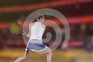 Female tennis player reaching to hit the tennis ball on court