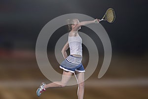 Female tennis player reaching to hit the tennis ball on court