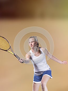 Female tennis player reaching to hit the tennis ball on court