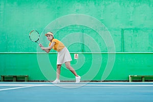 female tennis player ready to receive ball while holding racket