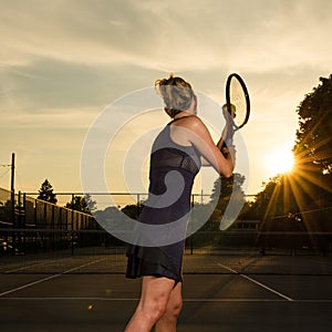 Female tennis player ready to serve photo