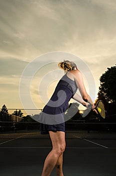 Female tennis player about to serve