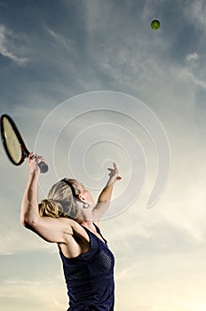 Female tennis player about to serve the ball