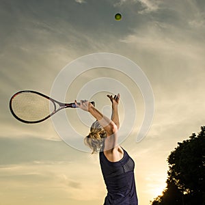 Female tennis player about to serve the ball photo