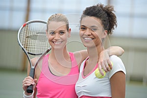 Female tennis players playing doubles at tennis court