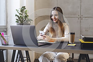 Female texting on smartphone. Manager having break at office, playing mobile games. Young woman commenting in social network app,