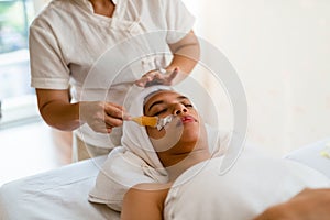 A female therapist doing Facial Spa/Treatment Add moisture to th