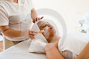 A female therapist doing Facial Spa/Treatment Add moisture to th