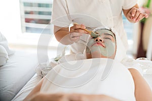 A female therapist doing Facial Spa/Treatment Add moisture to th