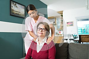 Nurse Taking Care Of Senior Patient At Home photo