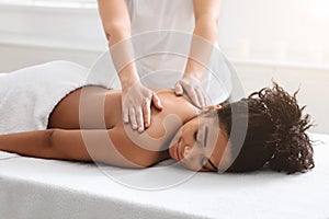 Female therapist rubbing sleeping african american lady back