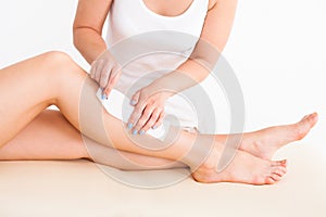 Female therapist waxing customer's leg