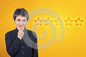 Female thinks of choosing five stars rating, positive feedback. Excellent customer service concept. Satisfied client voting survey