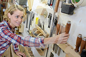 Female tidying up workshop