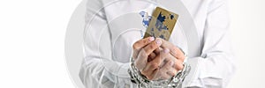 Female tied hands with plastic credit bank cards chain closeup