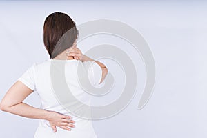 Female touching acute neck and lower back pain on white background with copy space. Medical, healthcare for advertising concept