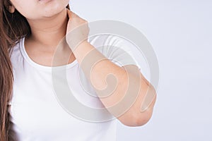 Female touching acute neck pain on white background with copy space. Medical, healthcare for advertising concept