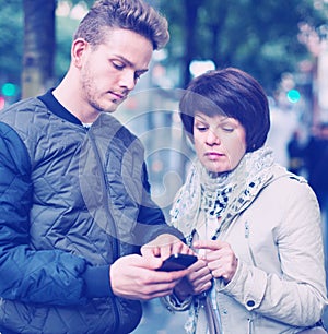 Female tourist asks for directions from local