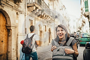 Female tourist backpacker visiting Italy.Woman in Syracuse,Sicily.Old town of Syracuse, Ortigia island visitor.Travel destination