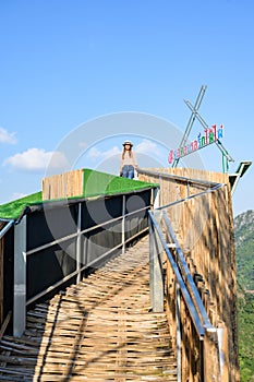 A female tourist on bamboo walkway at Pha Hi village