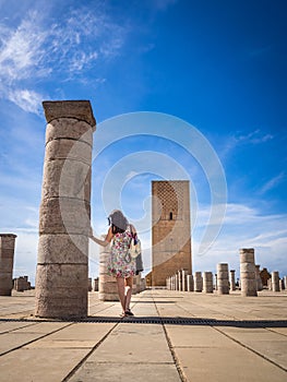 Female tourist enjoying the beautiful view of Tour Hassan in Rabat, Morocco