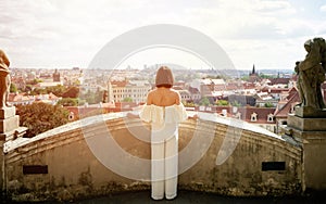 Female tourist enjoying great view on the old town of Prague,