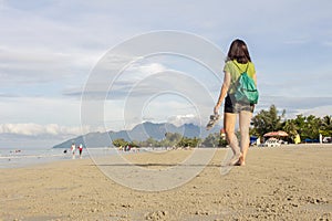 Female tourist enjoying summer holiday at a beach