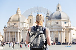 Female tourist with a fashinable vintage hipster backpack on Piazza del Popolo in Rome, Italy.