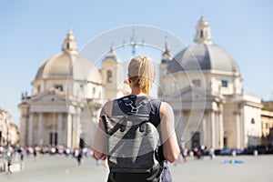 Female tourist with a fashinable vintage hipster backpack on Piazza del Popolo in Rome, Italy.