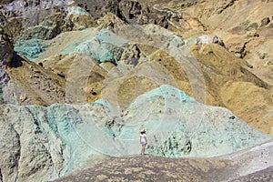 Female tourist in front of artists palette colorful mountains death valley
