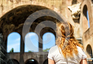 Female tourist in front of the Basilica of Maxentius and Constan