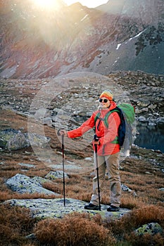 Female tourist hiking at High Tatras at gold sunset, Slovakia