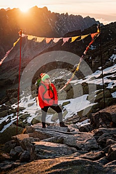 Female tourist hiking at High Tatras at gold sunset, Slovakia