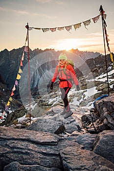 Female tourist hiking at High Tatras at gold sunset, Slovakia