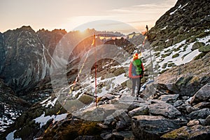 Female tourist hiking at High Tatras at gold sunset, Slovakia