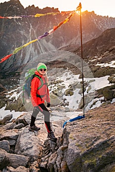 Female tourist hiking at High Tatras at gold sunset, Slovakia