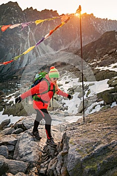 Female tourist hiking at High Tatras at gold sunset, Slovakia