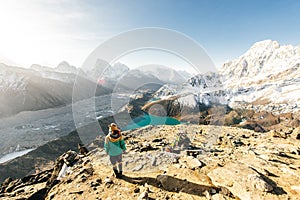 Female Tourist Hikking at gokyo ri mountain peak near gokyo lake during Everest base camp trekking in nepal photo