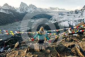 Female Tourist Hikking at gokyo ri mountain peak near gokyo lake during Everest base camp trekking in nepal