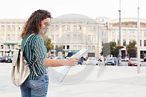 Female tourist holding map while exploring city